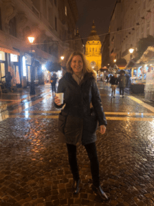 Tracy Streckenbach holding a coffee on a diligence trip 
